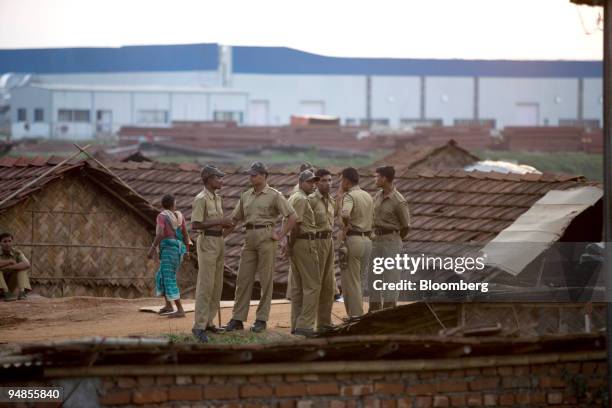 Indian police patrol in front of the unfinished Tata Nano plant during a protest in Singur, India, on Tuesday, Aug. 26, 2008. West Bengal Chief...