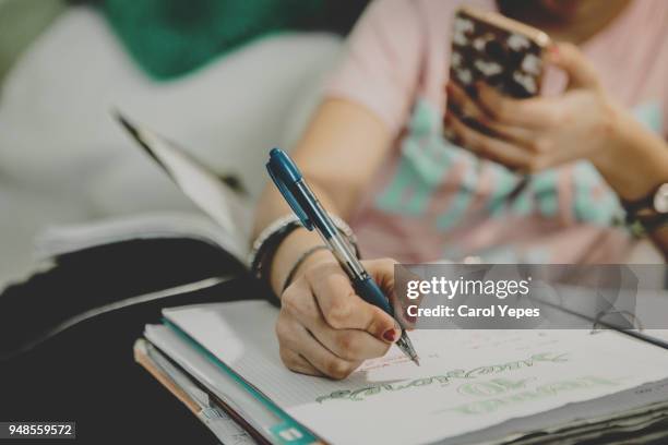 cropped image of teenager hand doing homework at home - university fotografías e imágenes de stock