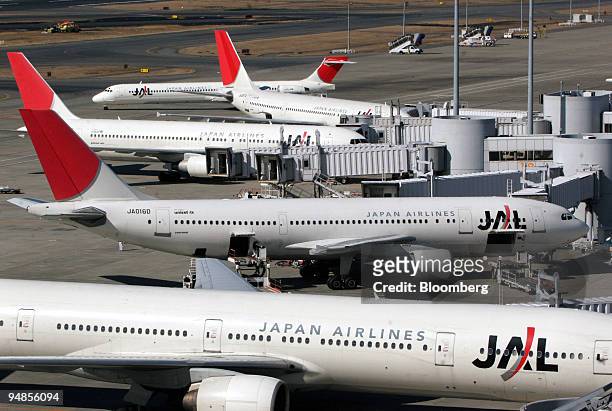 Japan Airlines Co. Ltd. Passenger jets sit parked at Haneda Airport in Tokyo, Saturday, February 4, 2006. Japan Airlines Corp.'s third-quarter loss...