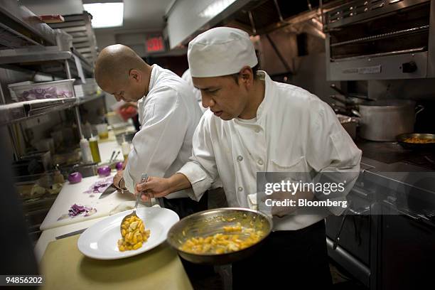 Ricky Barramco serves a dish of the crab and sea urchin malloreddus pasta at Convivio in New York, U.S., on Monday, Aug. 25, 2008. Michael White is...