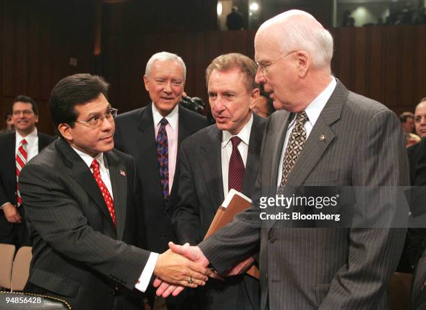 Attorney General nominee Alberto Gonzalez, left, shakes hands with Senator Patrick Leahy , right, before the start of a Senate Judiciary Committee...