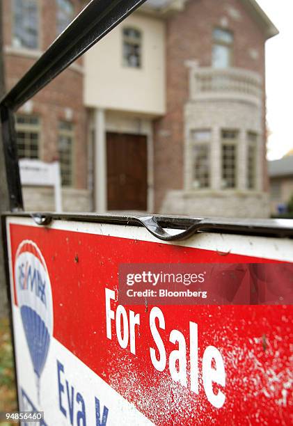 For sale sign stands outside a newly built home in Park Ridge, Illinois, U.S., on Thursday, Nov. 6, 2008.