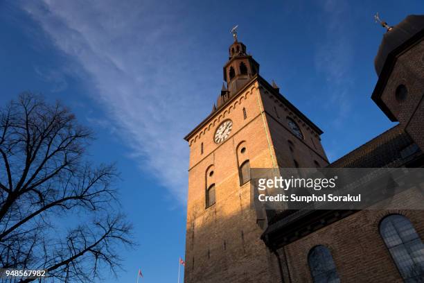 clock tower of oslo cathedral - sunphol stock-fotos und bilder