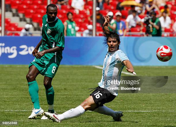 Sani Kaita of Nigeria, left, kicks the ball next to Ever Banega of Argentina, during the men's soccer final match on day 15 of the 2008 Beijing...