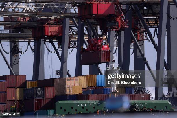 Ship-to-shore cranes load shipping containers onto cargo ship Thalassa Doxa at Terminal Burchardkai in the Port of Hamburg in Hamburg, Germany, on...