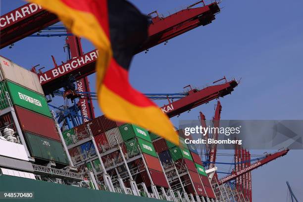 Shipping containers sit on board cargo ship Thalassa Doxa as the German national flag flies from a sightseeing boat at Terminal Burchardkai in the...