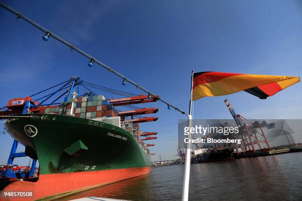 Shipping containers sit on board cargo ship Thalassa Doxa as the German national flag flies from a sightseeing boat at Terminal Burchardkai in the...