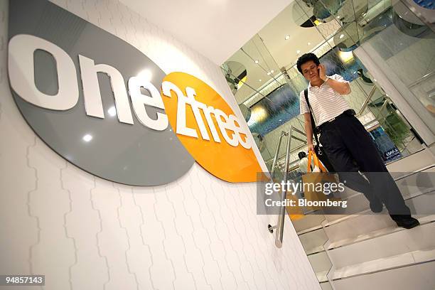 Man walks inside a One2Free store, owned by CSL New World Mobility Ltd., in Hong Kong, China, on Monday, May 5, 2008. CSL New World Mobility Ltd. Is...