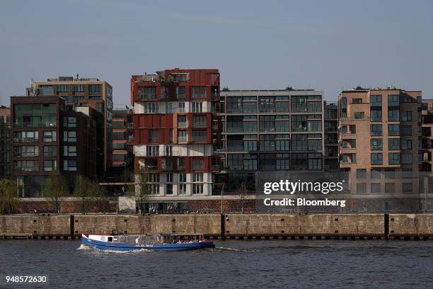 Residential apartment blocks stand on the bank of the river Elbe near the Port of Hamburg in Hamburg, Germany, on Wednesday, April 18, 2018. German...