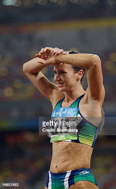 Maurren Higa Maggi of Brazil, holds her arms to her head following her attempt in the women's long jump on day 14 of the 2008 Beijing Olympics in...