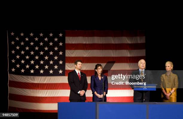 Senator John McCain of Arizona, Republican presidential nominee, at podium, along with his wife Cindy, right, Governor Sarah Palin of Alaska, his...