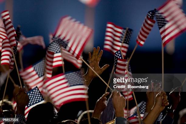 Supporters of Democratic president-elect Barack Obama wave flags as they react to the news of his election win during a rally in Grant Park in...