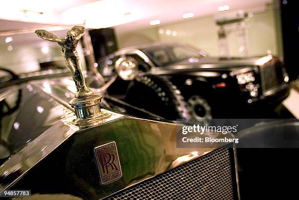 The Silver Ghost Rolls, once owned by Communist Party founder Vladimir Lenin, left, in Moscow, graces the first Rolls-Royce showroom in Russia,...