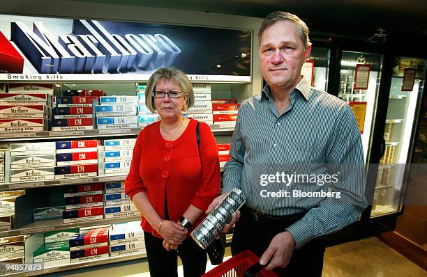 Gudrun Duvefjall and Christer Bjellert, a couple from Sweden, buy snus aboard the Viking Line ferry Mariella off the coast of Stockholm, Sweden, on...