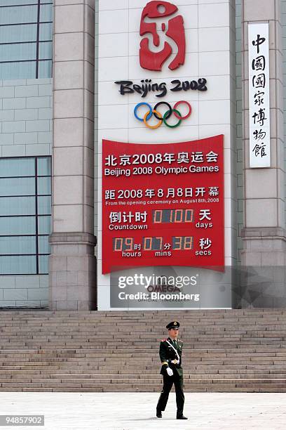 Chinese paramilitary police officer walks past a countdown clock for the Beijing 2008 Olympics near Tiananmen Square in Beijing, China, on Wednesday,...