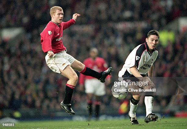 Paul Scholes of Manchester United shoots under pressure from Matt Holland of Ipswich during the FA Carling Premier League match played at Old...