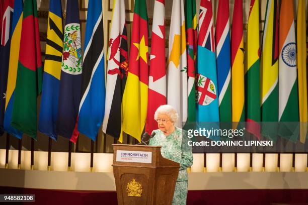 Britain's Queen Elizabeth II speaks at the formal opening of the Commonwealth Heads of Government Meeting at Buckingham Palace in London on April 19,...
