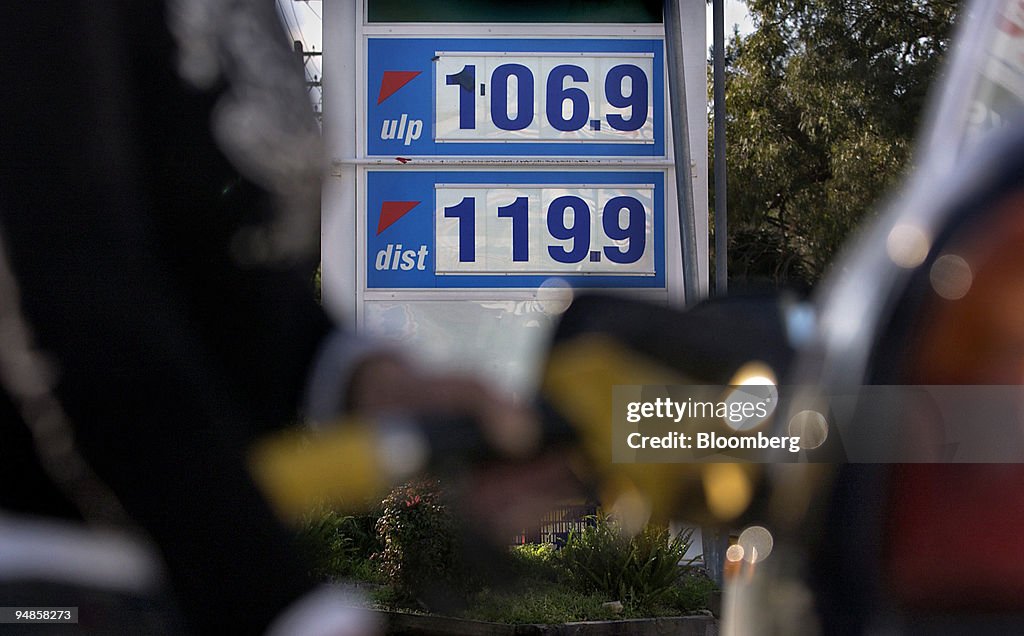 A motorist fills up at a service station in Sydney, Australi