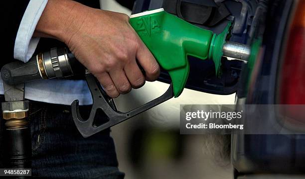Motorist fills up at a service station in Sydney, Australia on Monday, July 4, 2005. Record oil prices may increase to $80 a barrel this year,...