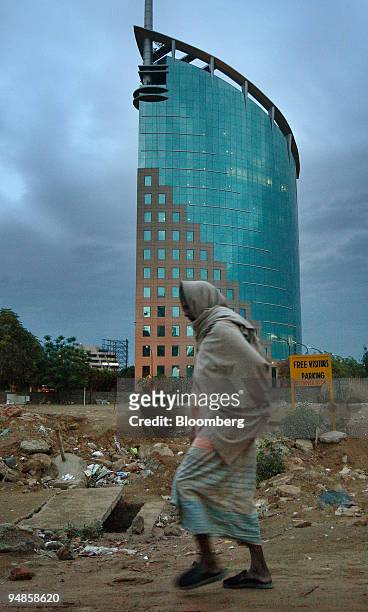 Man walks past the DLF Ltd. Gateway tower in Gurgaon, India, on Thursday, April 3, 2008. DLF Assets Ltd., the real-estate company owned by India's...