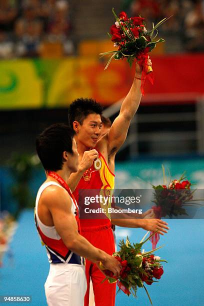 Li Xiaopeng of China, right, and Yoo Wonchul of South Korea, pose on the medal stand after the men's parallel bars final event on day 11 of the 2008...