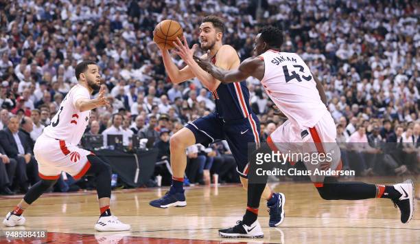 Tomas Satoransky of the Washington Wizards breaks between Fred VanVleet and Pascak Siakam of the Toronto Raptors in Game Two of the Eastern...