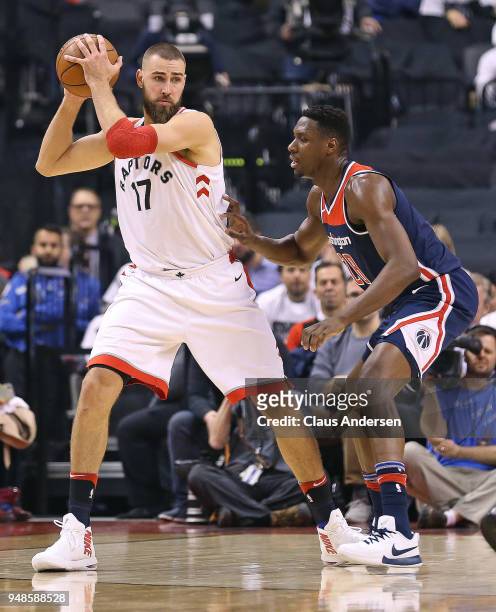 Ian Mahinmi of the Washington Wizards defends against Jonas Valanciunas of the Toronto Raptors in Game Two of the Eastern Conference First Round in...