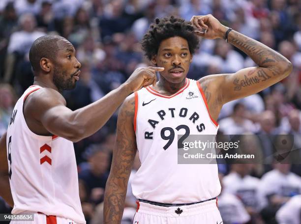 Serge Ibaka of the Toronto Raptors explains a play to teammate Lucas Nogueira during a timeout against the Washington Wizards in Game Two of the...