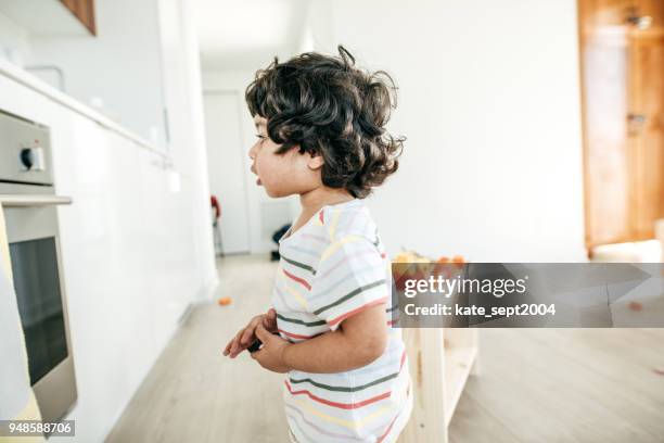 a curious child - indian boy standing stock pictures, royalty-free photos & images