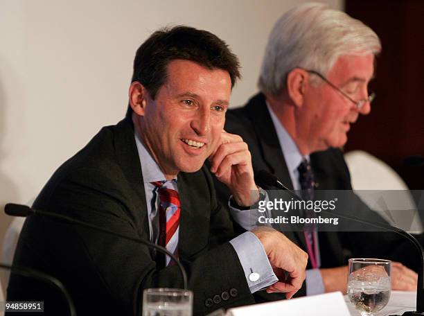 Former Olympian Sebastian Coe, left, chairman of London's delegation bidding for the 2012 Olympic Games, laughs next to fellow delegate Craig Reedie,...