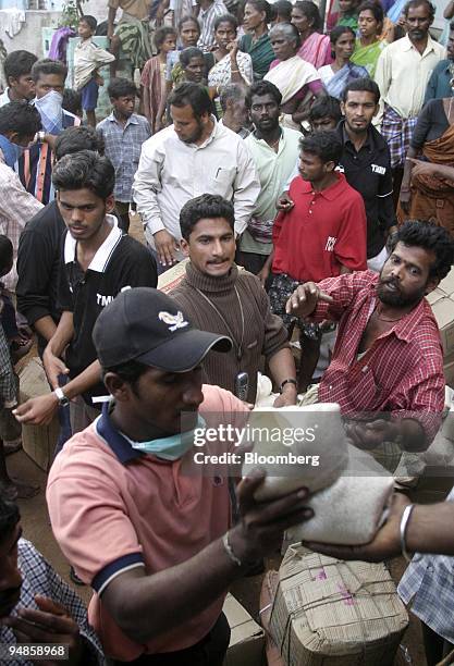 Rice and provisions are distributed in Nagapattinam, India on December 31, 2004. As the death toll from the December 26 earthquake-triggered tsunamis...
