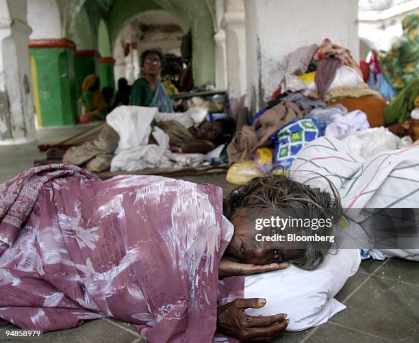 Woman rests with other displaced residents in Nagapattinam, India on December 31, 2004. As the death toll from the December 26 earthquake-triggered...