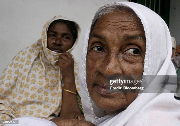 Woman rests with other displaced residents in a courtyard in Nagapattinam, India on December 31, 2004. As the death toll from the December 26...