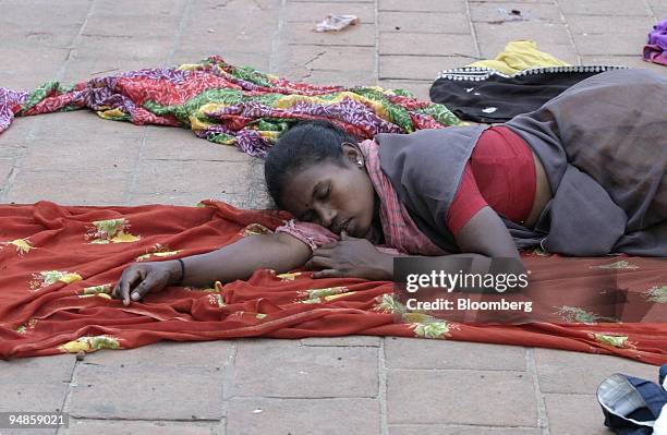 Woman sleeps on a sidewalk in Nagapattinam, India on December 31, 2004. As the death toll from the December 26 earthquake-triggered tsunamis in India...