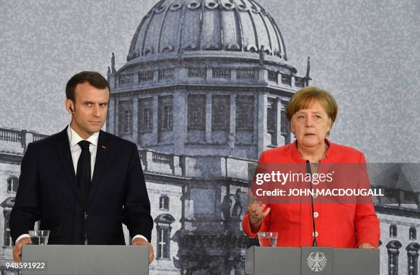 German Chancellor Angela Merkel and French President Emmanuel Macron give a joint press conference on April 19, 2018 in Berlin before holding talks...