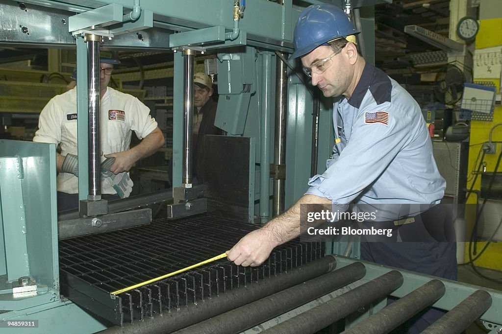 Sacir Sovsic, right, measures a steel grid he is preparing t