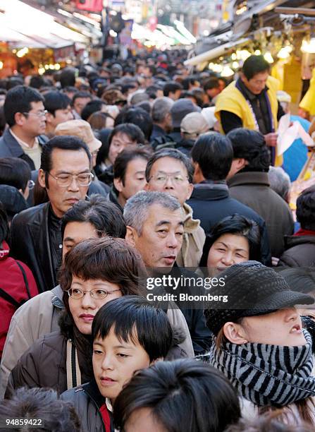 Crowd of year-end shoppers fills a street at the Ameyoko market in Tokyo, Japan on Thursday, December 30, 2004.