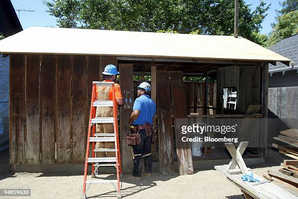 Ken Hendrickson, left, and Jimmy Reyes work on a portion of the 'HP garage' on the grounds of 367 Addison Ave. In Palo Alto, California Thursday,...