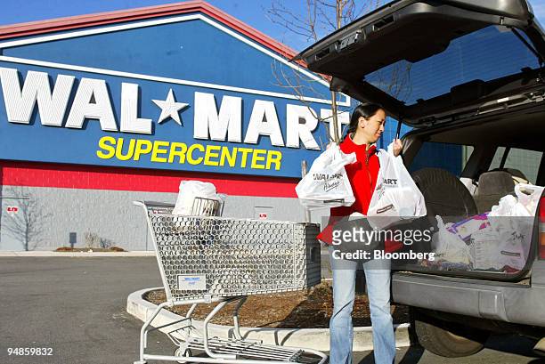 Christy Heil unloads her shopping cart into the back of her truck, outside a Wal-Mart Supercenter on Tuesday, November 16 in Waterford, Connecticut....