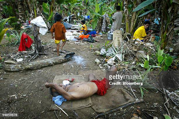 Homeless family rests outdoors in Car Nicobar islands Tuesday December 28, 2004 after a tsunami hit the Southern Indian Islands of Andaman and...