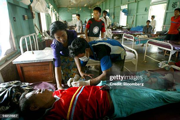 An injured man receives stitches in a hospital in Car Nicobar islands Tuesday December 28, 2004 after a tsunami hit the Southern Indian Islands of...