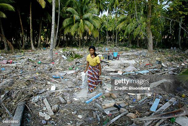 Girl walks through her home which was destroyed in Car Nicobar islands Tuesday December 28, 2004 after a tsunami hit the Southern Indian Islands of...