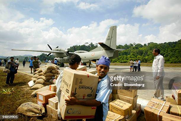 Relief material is off-loaded at Cambal Bay islands Tuesday December 28, 2004 after a tsunami hit the Southern Indian Islands of Andaman and Nicobar...