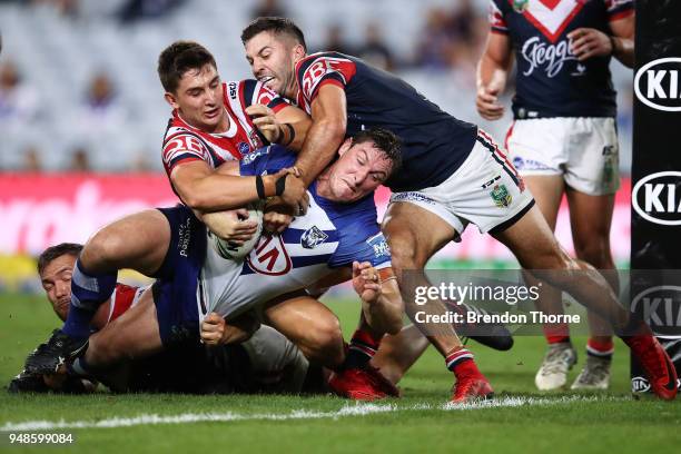 Joshua Jackson of the Bulldogs is tackled by Roosters defence during the round seven NRL match between the Canterbury Bulldogs and the Sydney...
