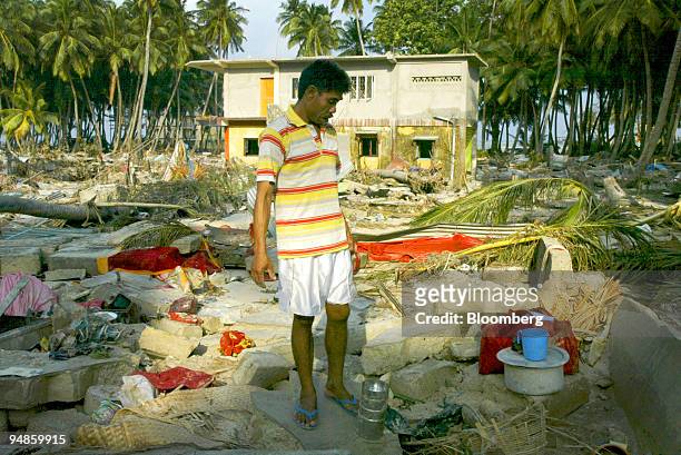 Man looks at his lost belongings in Car Nicobar islands Tuesday December 28, 2004 after a tsunami hit the Southern Indian Islands of Andaman and...