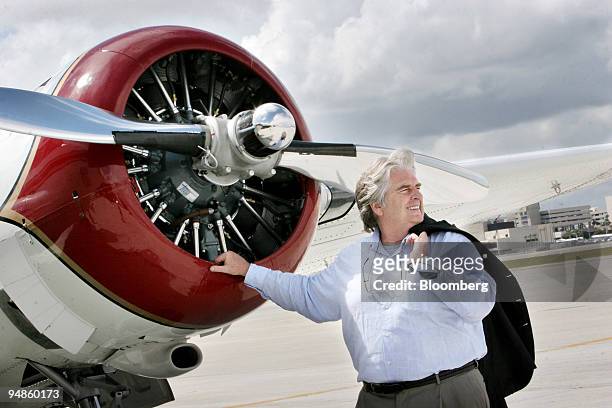 Don Binns, contemporary art dealer, poses for a portrait with his 1950's reconditioned twin-engine Beechcraft plane at the executive airport in Palm...