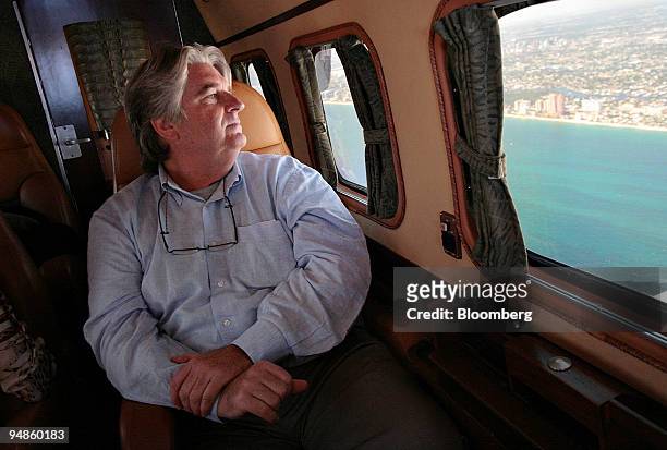 Don Binns, contemporary art dealer, looks out of the window of his 1950's reconditioned twin-engine Beechcraft plane as he is flown to a business...