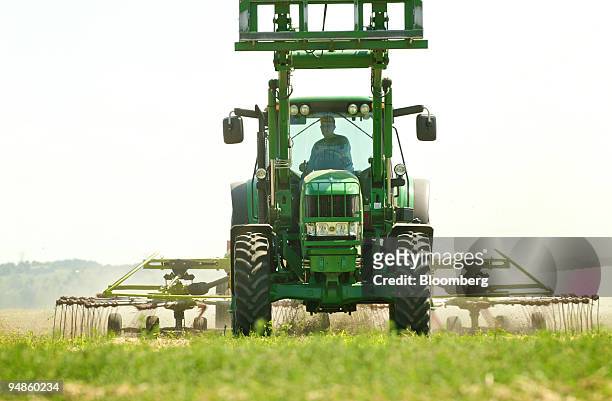 Cut alfalfa is raked into rows before being baled on the Freeburg Hay Farm in Gayville, South Dakota, U.S., on Monday, Aug.18, 2008. Net farm income...