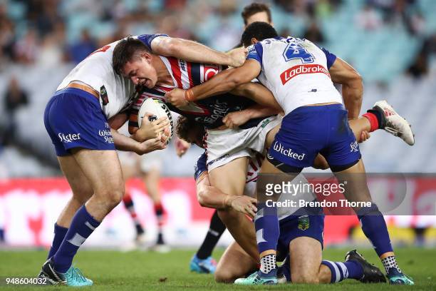 Joseph Manu of the Roosters is tackled by the Bulldogs defence during the round seven NRL match between the Canterbury Bulldogs and the Sydney...