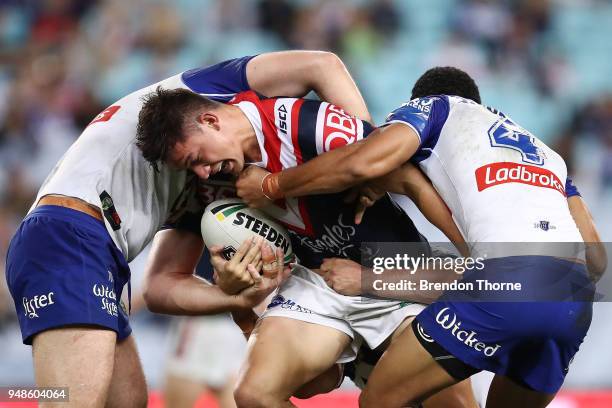 Joseph Manu of the Roosters is tackled by the Bulldogs defence during the round seven NRL match between the Canterbury Bulldogs and the Sydney...